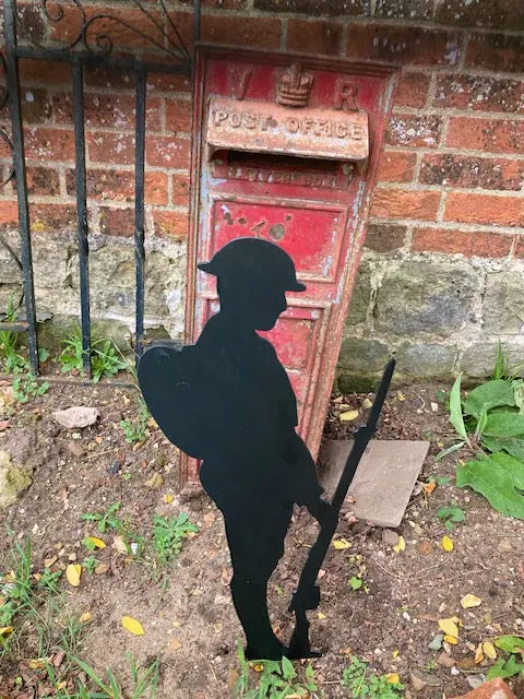 Black metal silhouette of soldier with backpack, gun and helmet solemnly looking down in respect of their fallen comrades. Made from strong 2mm thick metal and finished in a rust proof silk paint.