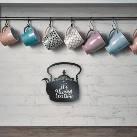 Metal wall decor of a tea pot with wording Good Morning its always tea time