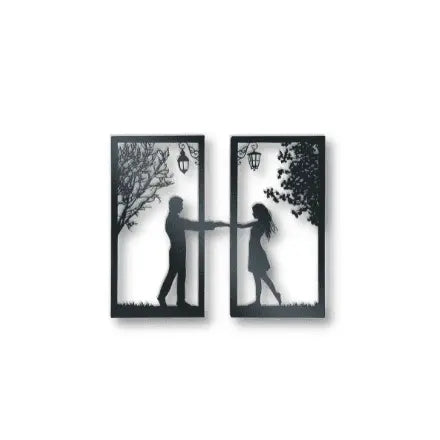 Metal wall art of boy and girl standing under a tree and lamp arms stretched out holding hands