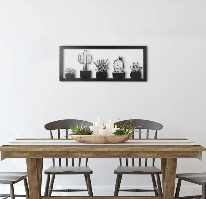 Metall wall decor showing five types of cacti in a frame, cut with great detail and gives a 3D effect on the wall behind